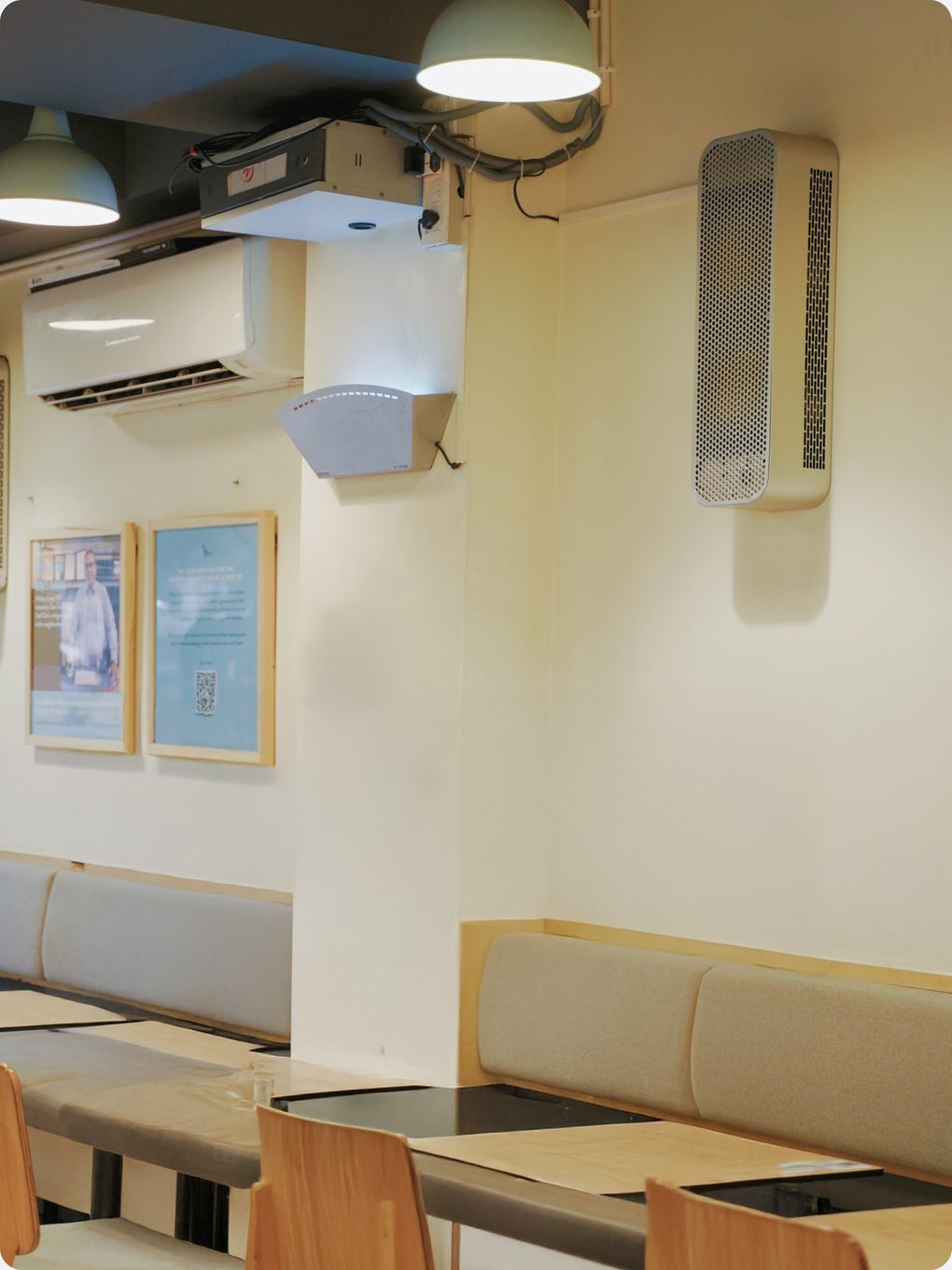 HIVE wall-mounted beside an air conditioner in a restaurant